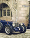 vintage sports car wallpaper featuring a classic blue sports car in an elegant European street setting.