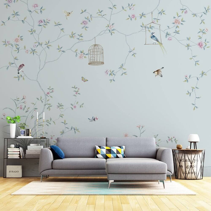 Light Blue Chinese Floral & Bird Wallpaper Mural | Elegant Birdcage Motif in a serene living room with pastel blossoms, birds, and a chic gray sofa