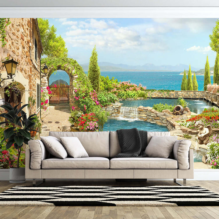 Mediterranean courtyard wallpaper | Sea view garden style mural with blue-green sea, lush plants, stone villa and pool backdrop for a romantic European vibe