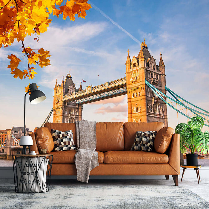 Tower Bridge Landscape Wallpaper Mural | Living Room Decoration Painting: London landmark autumn cityscape featuring Tower Bridge, warm tan sofa, cozy throws, and modern décor