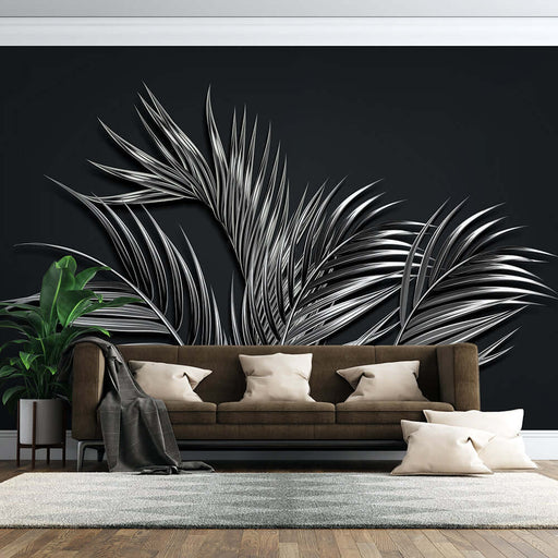 Black background silver palm wallpaper mural | Unique artistic atmosphere: tropical palm leaves on dark wall behind brown sofa for dramatic, modern luxurious interior