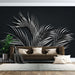 Black background silver palm wallpaper mural | Unique artistic atmosphere: tropical palm leaves on dark wall behind brown sofa for dramatic, modern luxurious interior