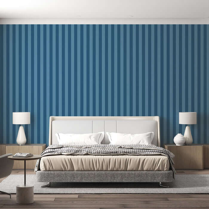 Blue Striped Wallpaper - Minimalist Ocean Dream Décor in a serene bedroom setting with vertical blue stripes behind a modern upholstered bed.