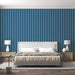 Blue Striped Wallpaper - Minimalist Ocean Dream Décor in a serene bedroom setting with vertical blue stripes behind a modern upholstered bed.