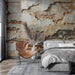 Broken wall wallpaper mural in a chic bedroom with exposed brick and peeling plaster, rustic tones, sculptural chair, and cozy gray bedding