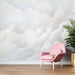 Cloud wallpaper mural | Living room bedroom decorative wall: soft pink chair by a cloud-themed wall for a calming, minimalist look