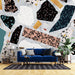 Colorful terrazzo wallpaper mural | trendy collage style wallpaper in a modern living room with bold terrazzo patterns on a feature wall behind a blue sofa