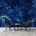 Deep Blue Tropical Plant Wallpaper Mural | Living Room and Bedroom Decoration with dark navy leaves backdrop and modern seating