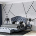 Geometric marble wallpaper | Geometric line decorative mural in elegant blue bedroom with tufted headboard, dramatic black lines, and modern nightstands