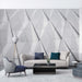 Geometric Triangle Wallpaper Mural | Advanced Grey Tone - Futuristic 3D triangle wall design in a modern living room with sleek gray tones, minimalist furniture, and luxurious ambiance