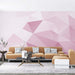 Gradient geometric wallpaper mural | Dreamy and minimalist decorative wall in a pastel pink-purple 3D polygon design with a modern tan sofa living room