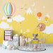 Hot air balloon animal playful wallpaper | Children's bedroom mural with whimsical balloons, mountains, clouds and playful animals in a bright kids' room
