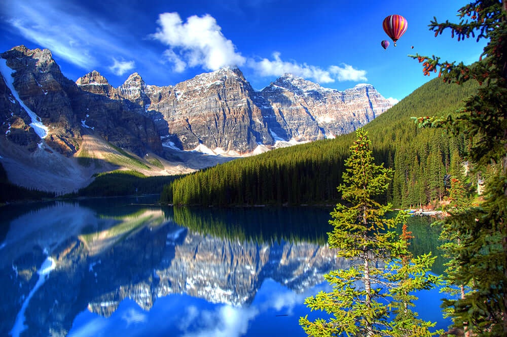 Landscape Wallpaper Mural | Natural Landscape Wall Decoration: Banff Park-inspired scene with blue lake, snow-capped mountains, evergreen forest, and hot air balloons