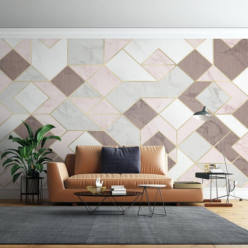 Luxury Geometric Marble Wallpaper Mural – Pink, Gray & White with Gold Accents in a stylish living room with a tan leather sofa, geometric walls, and modern coffee tables