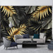 Luxury Tropical Wallpaper | Gold & Green Botanical Mural on Black — lush gold leaves and dark green foliage on matte black background in a modern living room setting