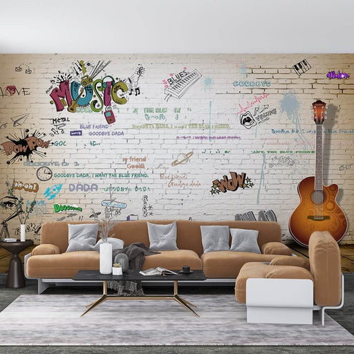 Music Brick Wall Mural - Trendy Graffiti Wallpaper: vibrant graffiti mural on brick wall with 'Music' typography, guitar illustration, and urban art accents in a modern living room