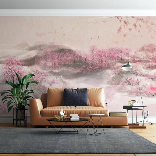 Serene Cherry Blossom Ink Wash Mural - Zen Wallpaper for Bedroom & Living Room in a modern living room with pink blossoms, misty mountains, and a tan leather sofa