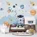 Space astronaut playful wallpaper | Children's bedroom mural featuring astronaut, rockets, and planets for an interstellar-themed kids room