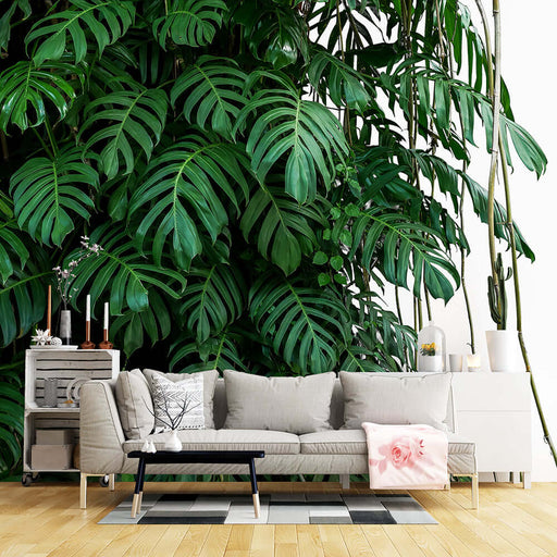 Tropical Leaf Wallpaper Mural | Natural Green Plant Background Wall — lush monstera-like leaves backdrop behind modern living room sofa for vibrant tropical vibe