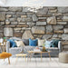 Vintage stone wall texture wallpaper in a stylish living room with cozy furniture and decorative elements.