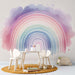 Watercolor rainbow wallpaper mural in a kids room, featuring soft pastel colors and a dreamy design.