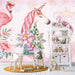Watercolor unicorn flamingo wallpaper in a stylish girl's room with floral elements and decor.