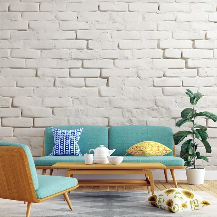 White brick textured wallpaper mural | Nostalgic style - minimalist living room with teal sofa, modern chairs, and plants